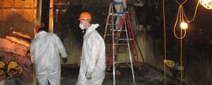 Hurricane Damage Repair Technicians Cleaning Up A Flooded Local Business