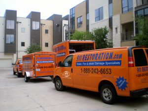 Fleet Of Water Mitigation Vehicles At A Commercial Job Site