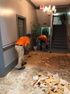 Technicians Repairing A Floor After A House Flood