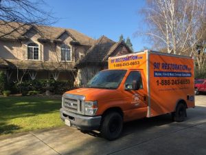 Water Damage Restoration Team At A Residential Job Site